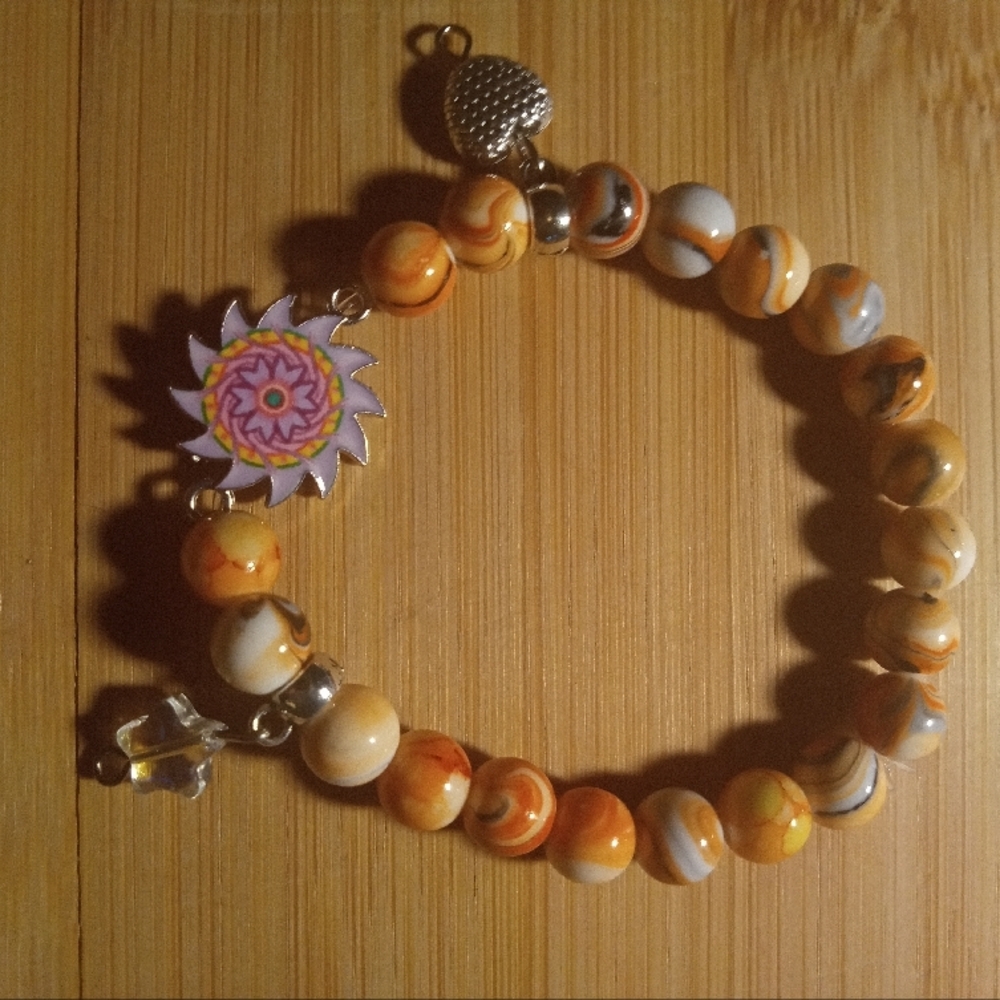 Orange and White Beaded Bracelet with Sun Charm